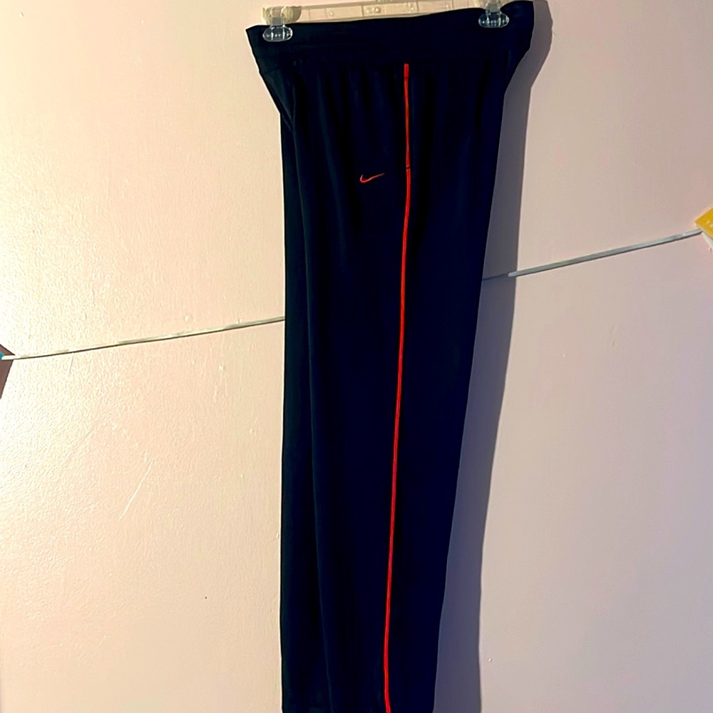 Large Dri-fit men’s pants all black with a red stripe.